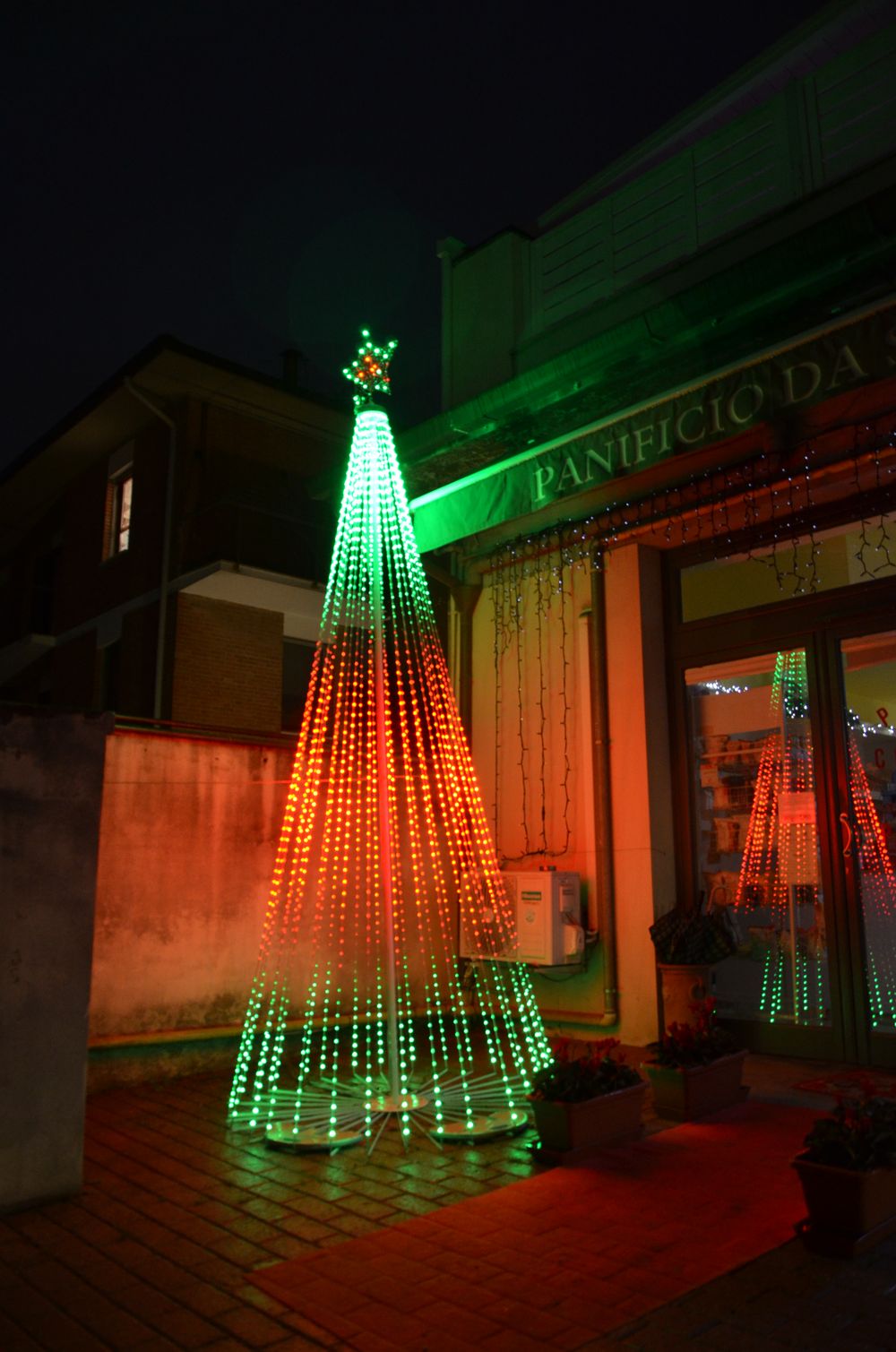 Albero luminoso a cascata davanti a un panificio